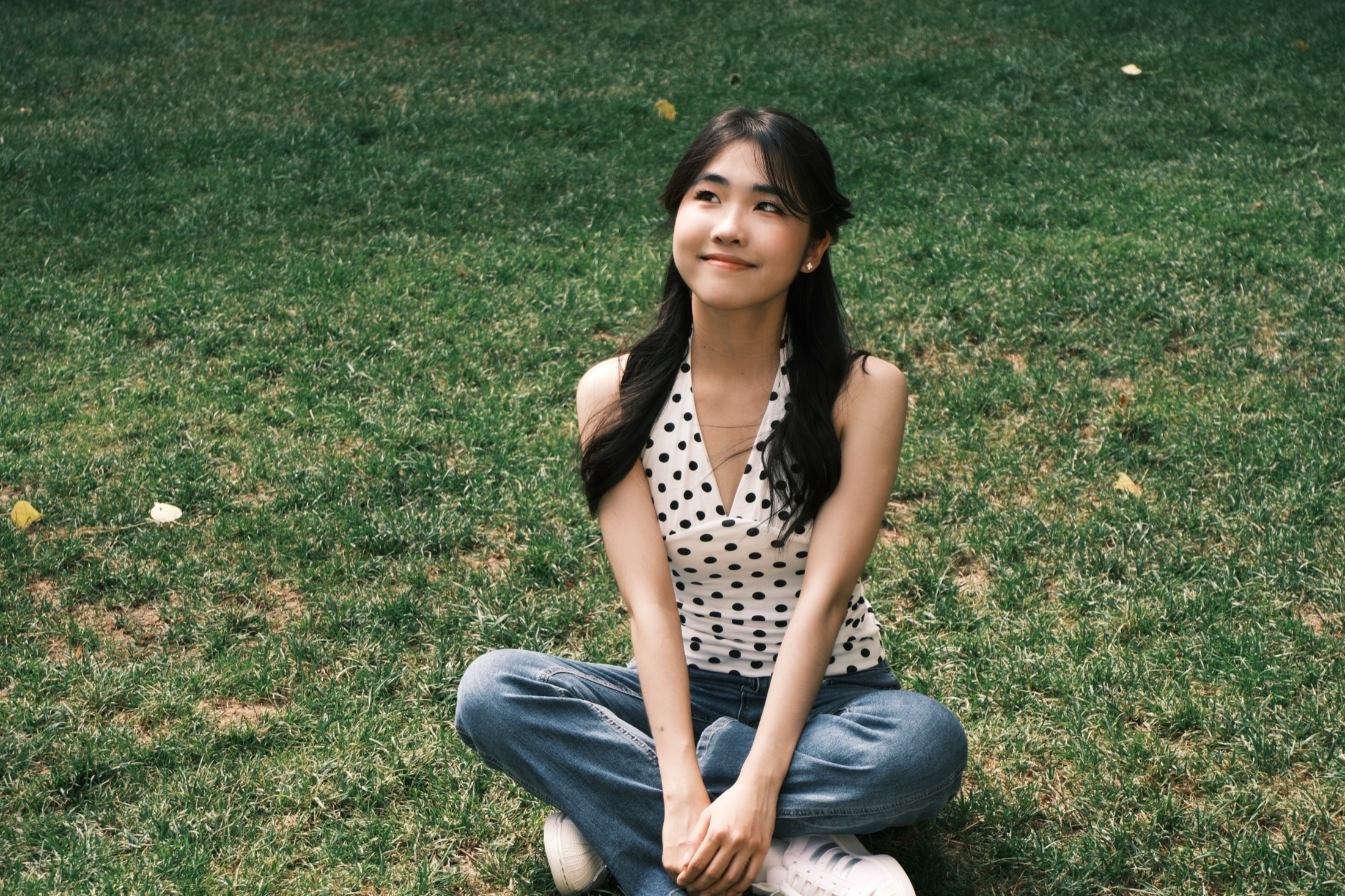Casey Jiang seated on a green lawn